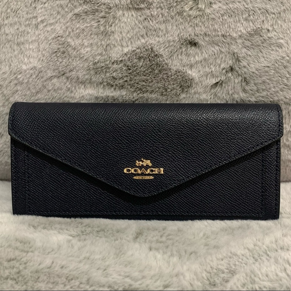 Never been used Coach wallet in navy blue color! Plenty of compartments!